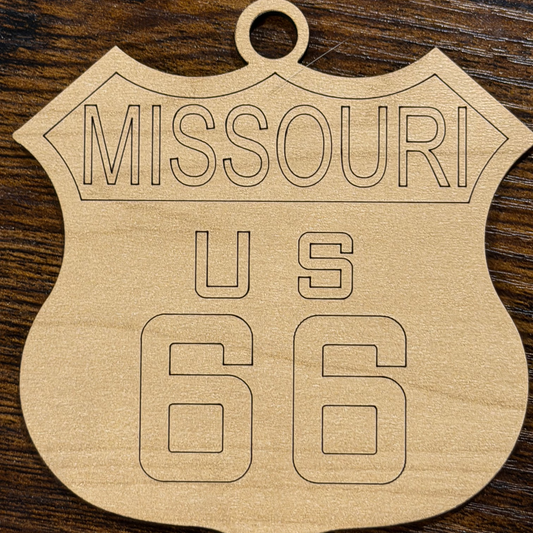 Wooden ornament with 'Missouri US 66' engraving on a wooden surface