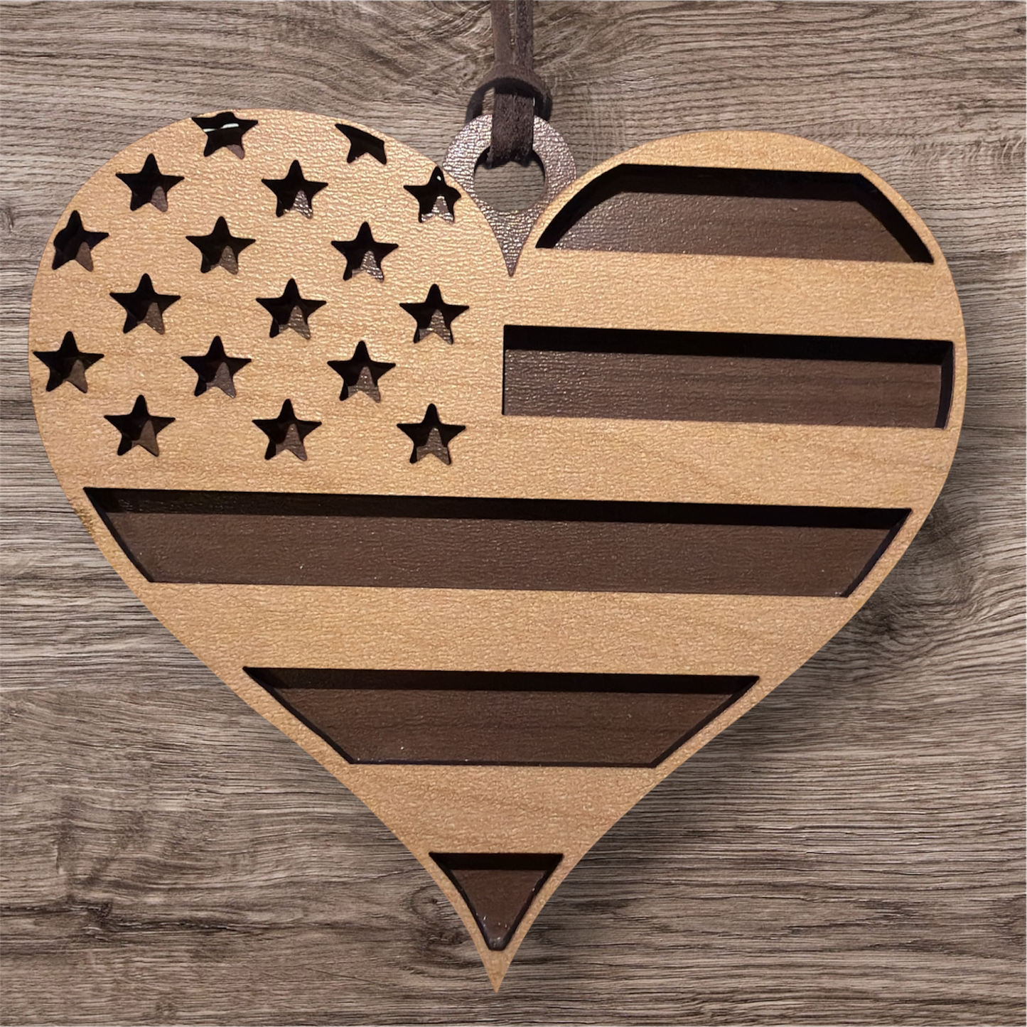 Wooden heart-shaped American flag ornament on a wooden background