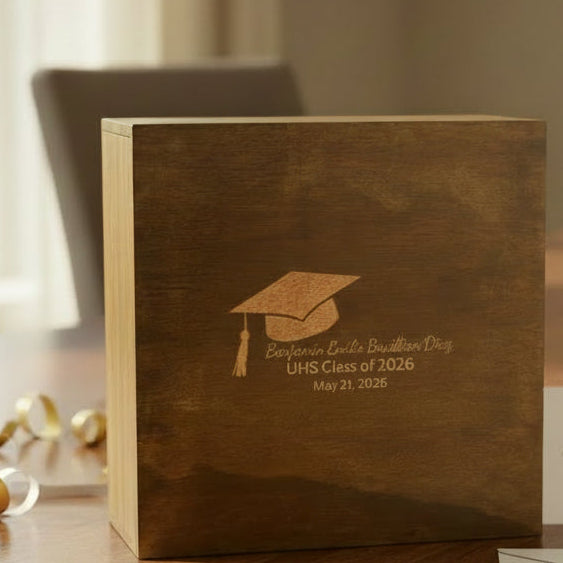 Wooden box with graduation design and text on a concrete surface