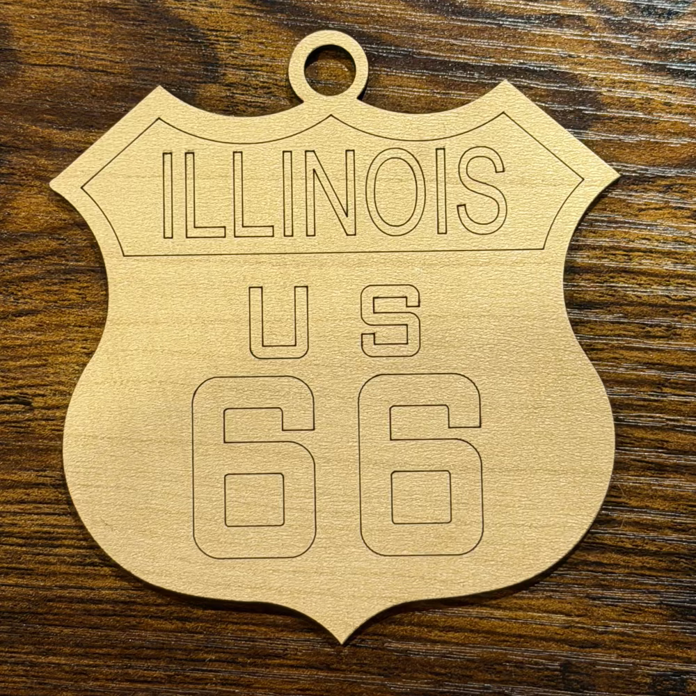Wooden shield-shaped sign with 'ILLINOIS' and '95' engraving on a wooden surface