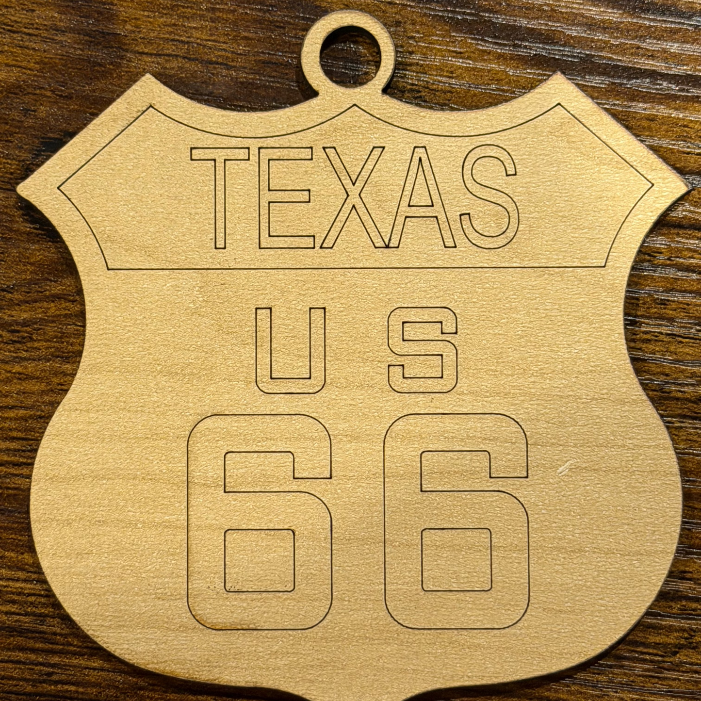 Wooden ornament with 'Texas US 66' engraving on a wooden background